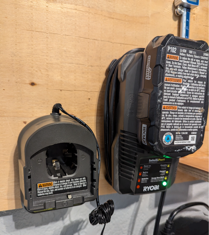 Ryobi 18V charger wall mount holding a charger, mounted on wall